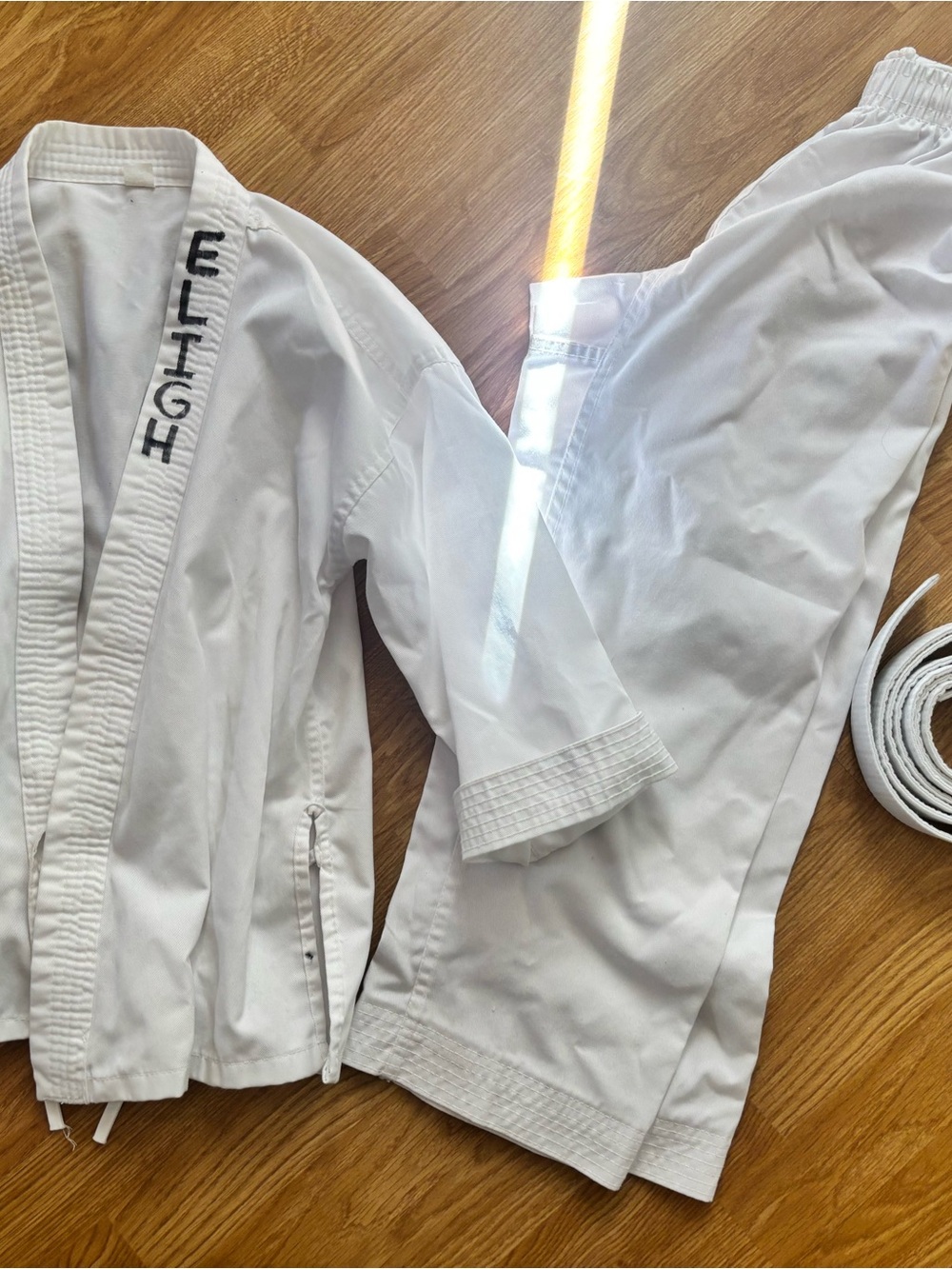 White Martial Arts Gi Pants and top with white belt.